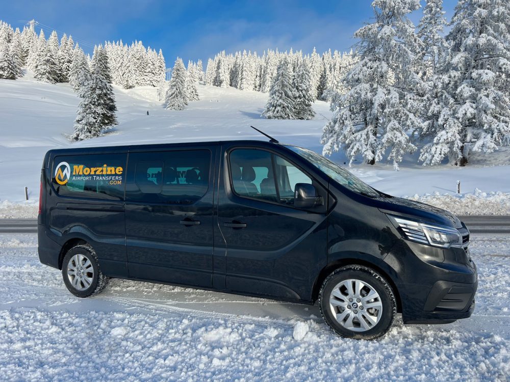 Modern shuttle van for Geneva to Morzine transfer parked in scenic Alpine landscape